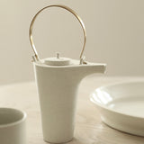 Kin Leung Grog porcelain white teapot with a brass handle