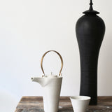 Kin Leung Grog porcelain white teapot with a brass handle